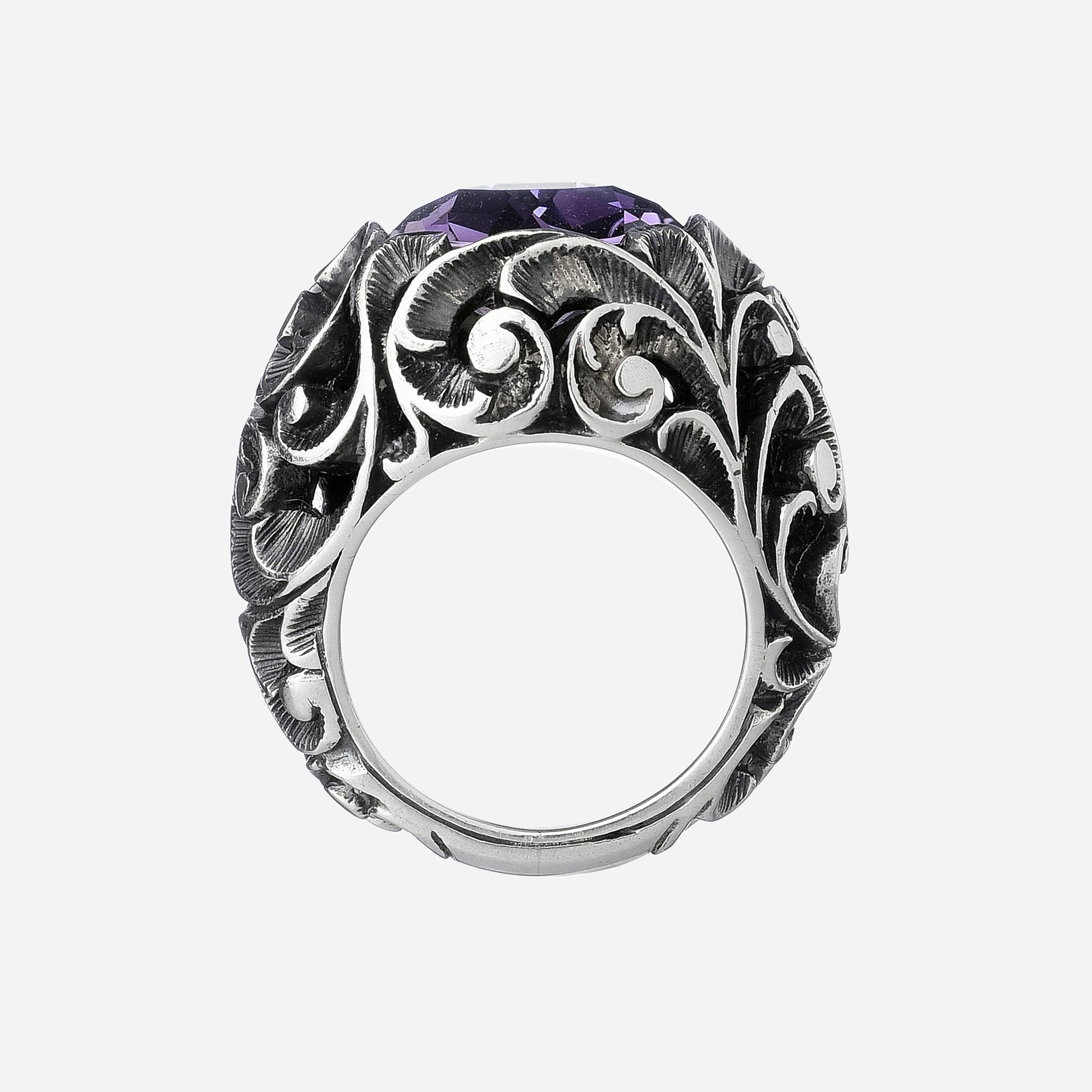 Ring with faceted round cut stone